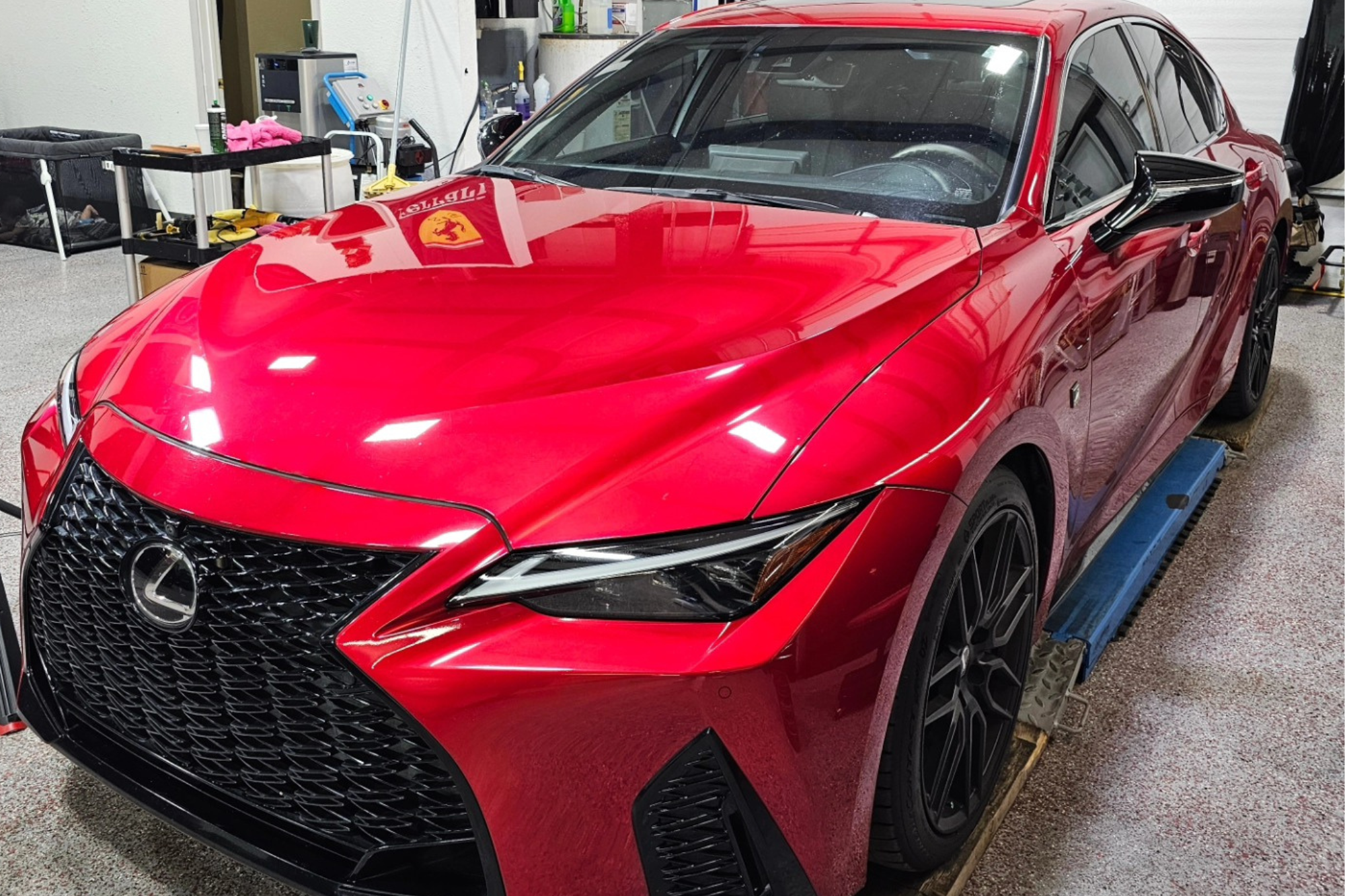 A striking red Lexus IS F Sport showcasing its sleek design and sporty features, emphasizing luxury and performance.